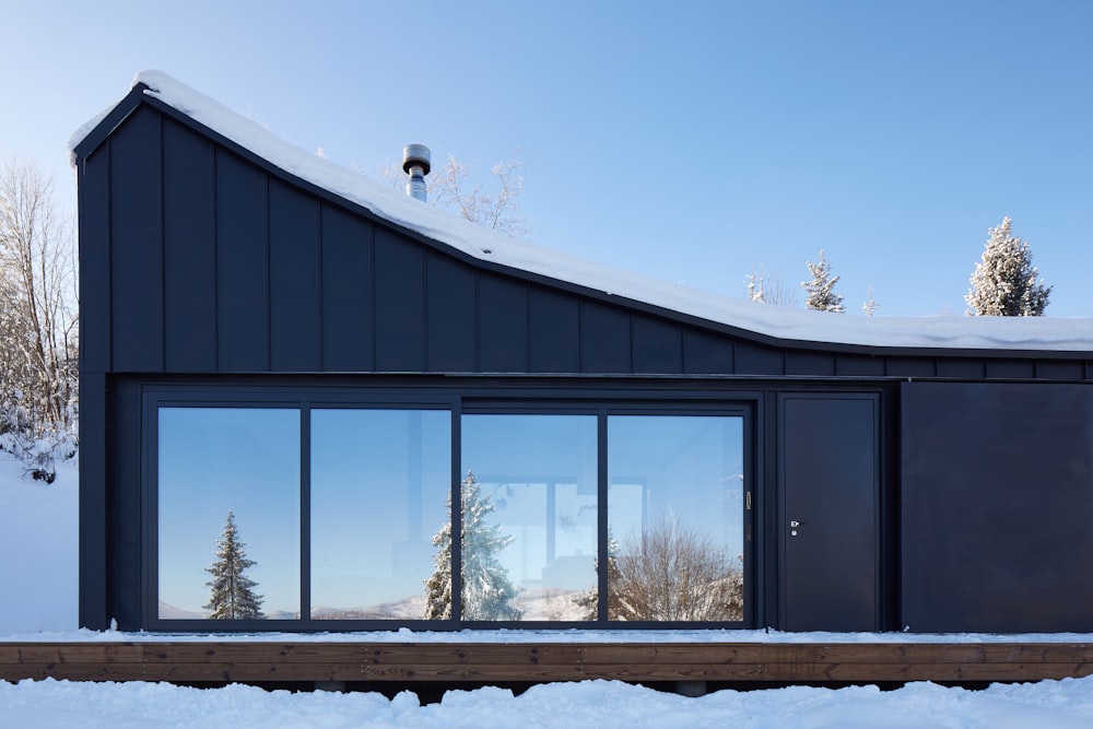 black building with glass window panel on ice ground during daytime