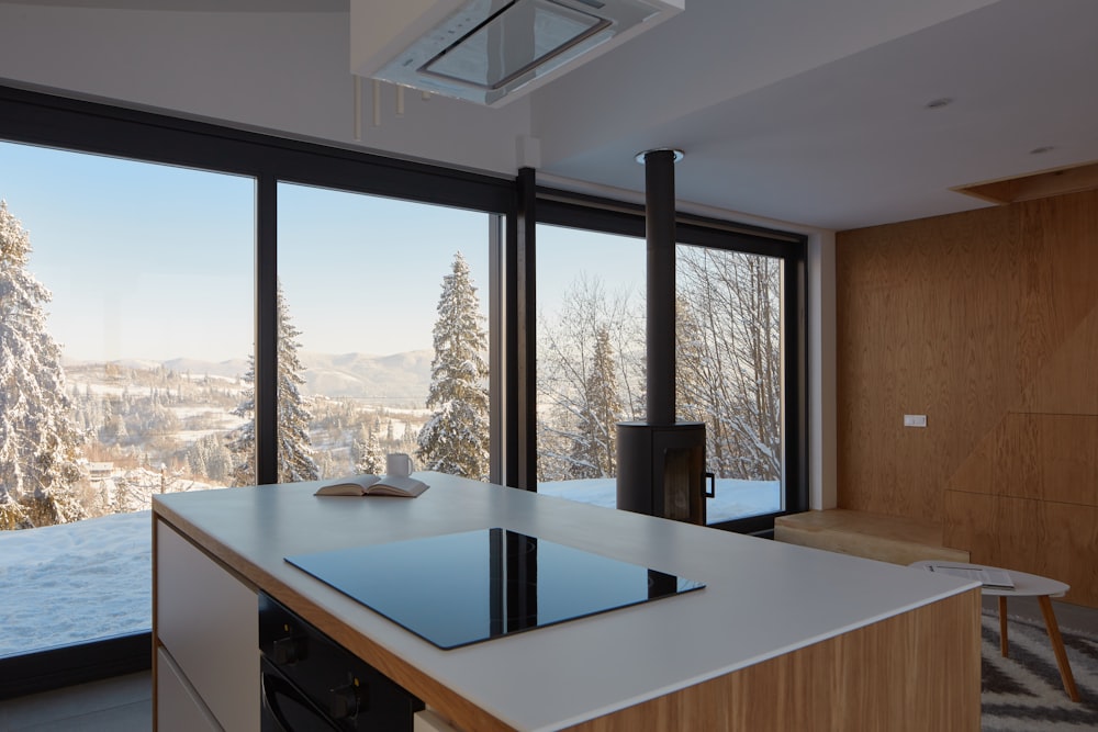 white and brown wooden table beside window