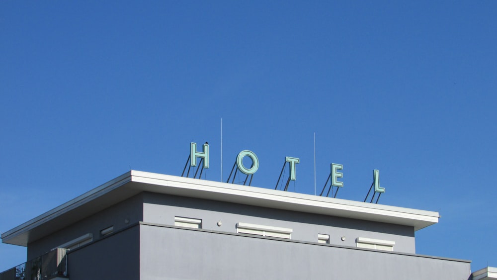 gray and white Hotel signage during daytime