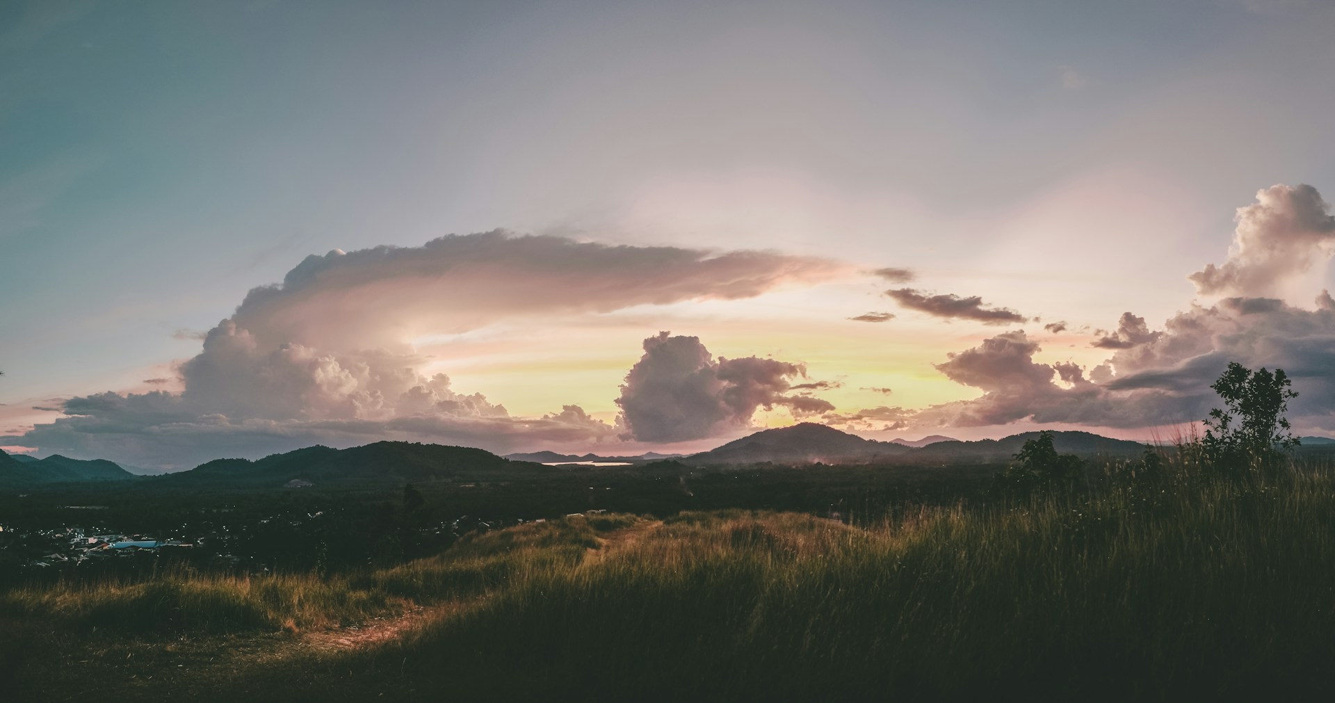 woman wearing yellow long-sleeved dress under white clouds and blue sky during daytime