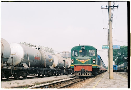 green and yellow train near post