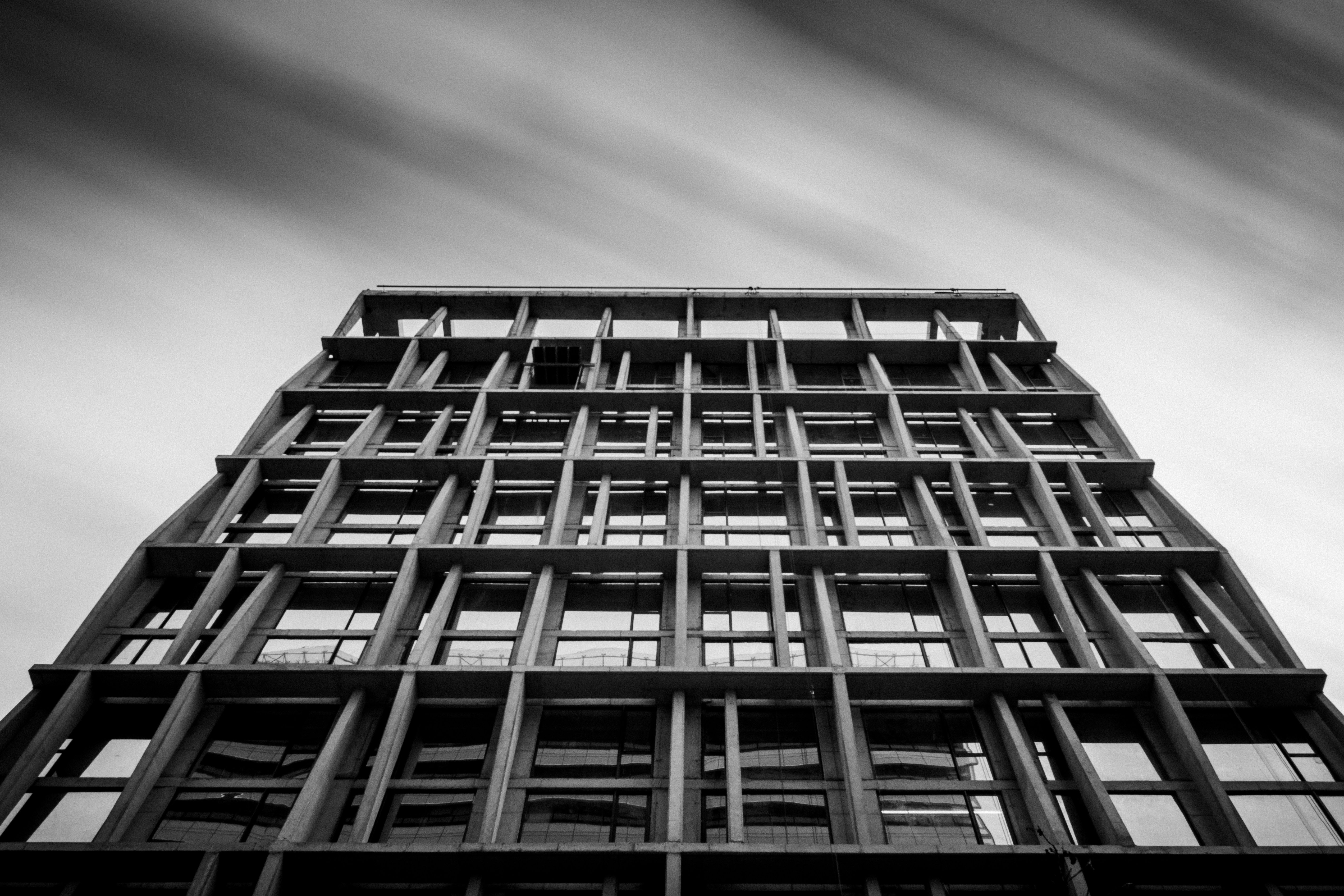 grayscale photography of concrete building noir zoom background