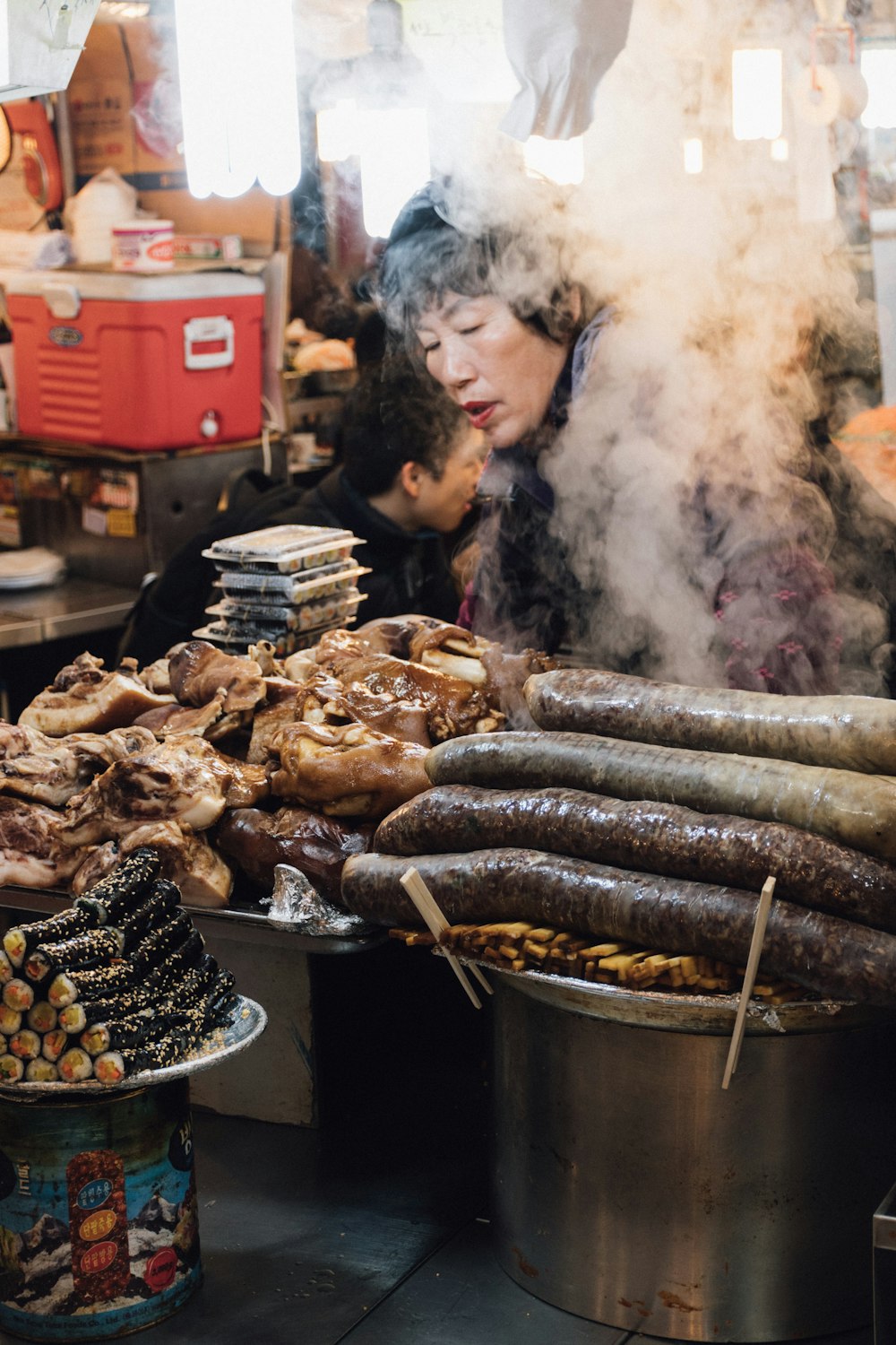 woman standing in front of assorted grilled food