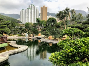 A landscape view of a beautifully landscaped garden featuring a natural pond.