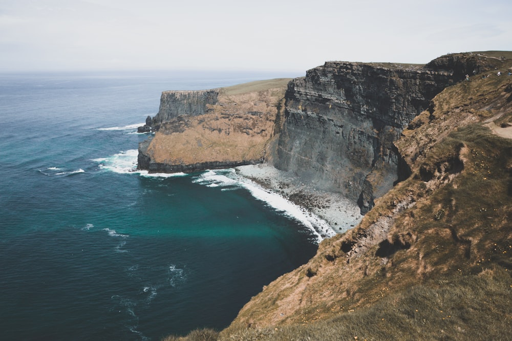 ocean wave splashing on rock formation during daytime