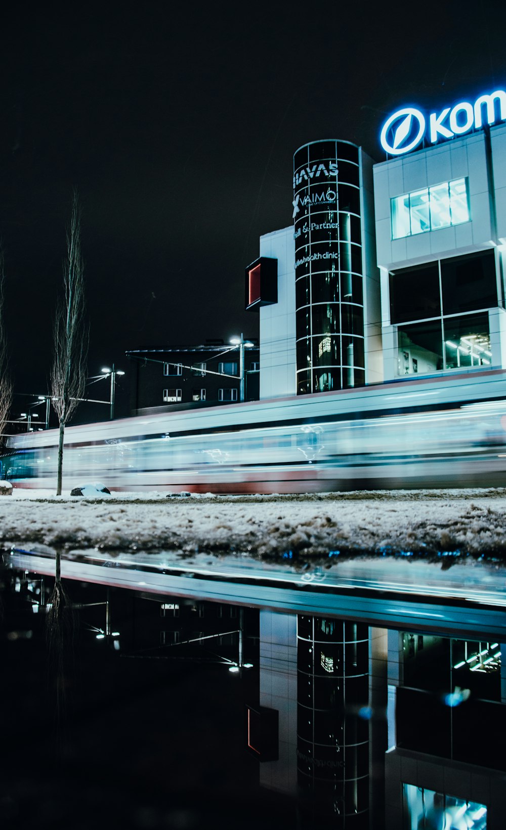 a blurry photo of a building with a kodak sign in the background