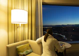 A cozy scene of a person lounging in a soft inphinity sweater with city lights in the background.