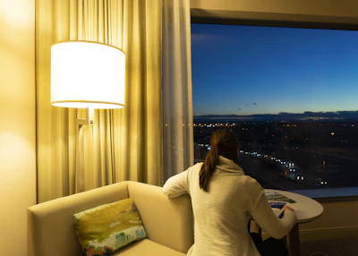 A cozy scene of a person lounging in a soft inphinity sweater with city lights in the background.