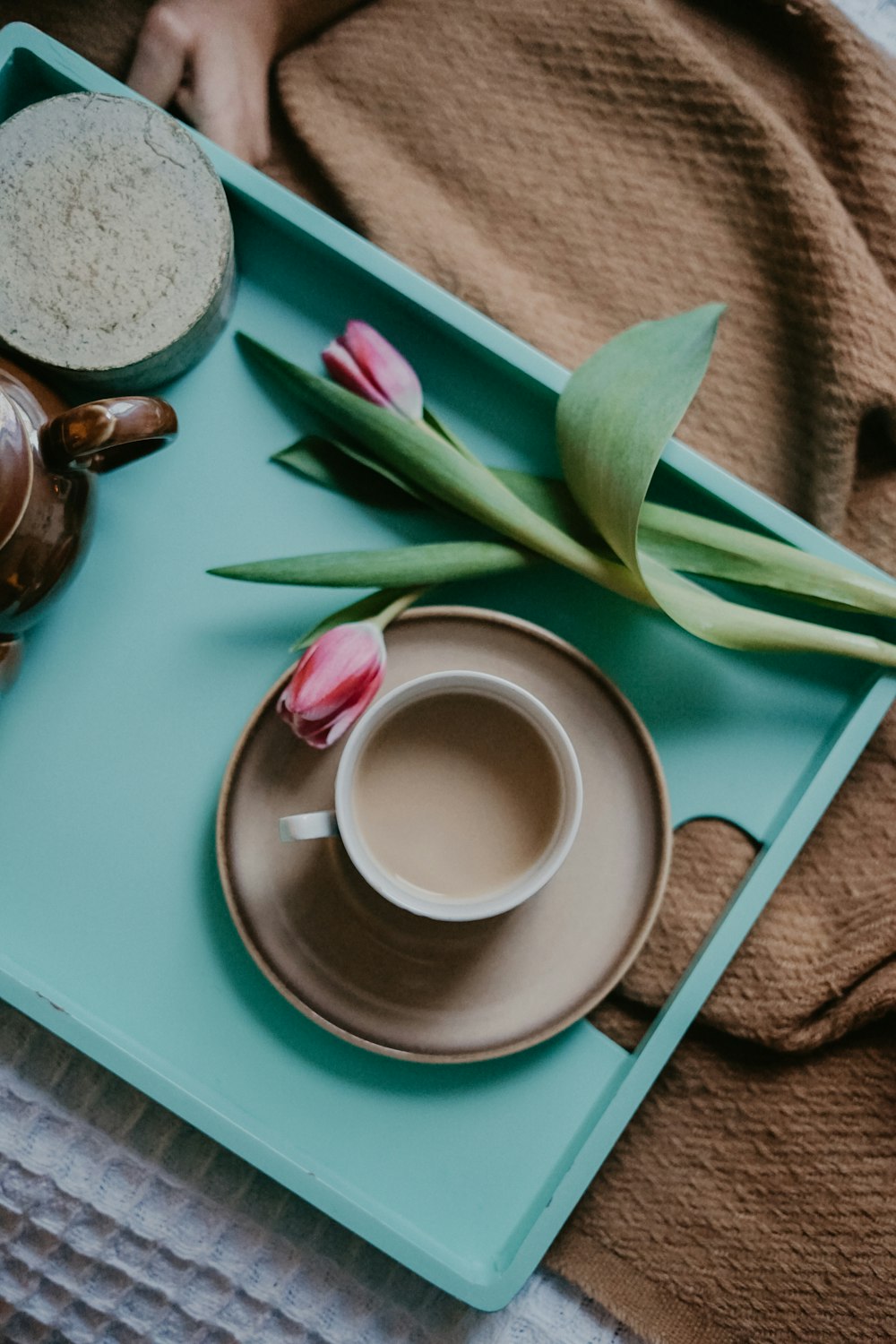 teacup filled with brown liquid on food tray