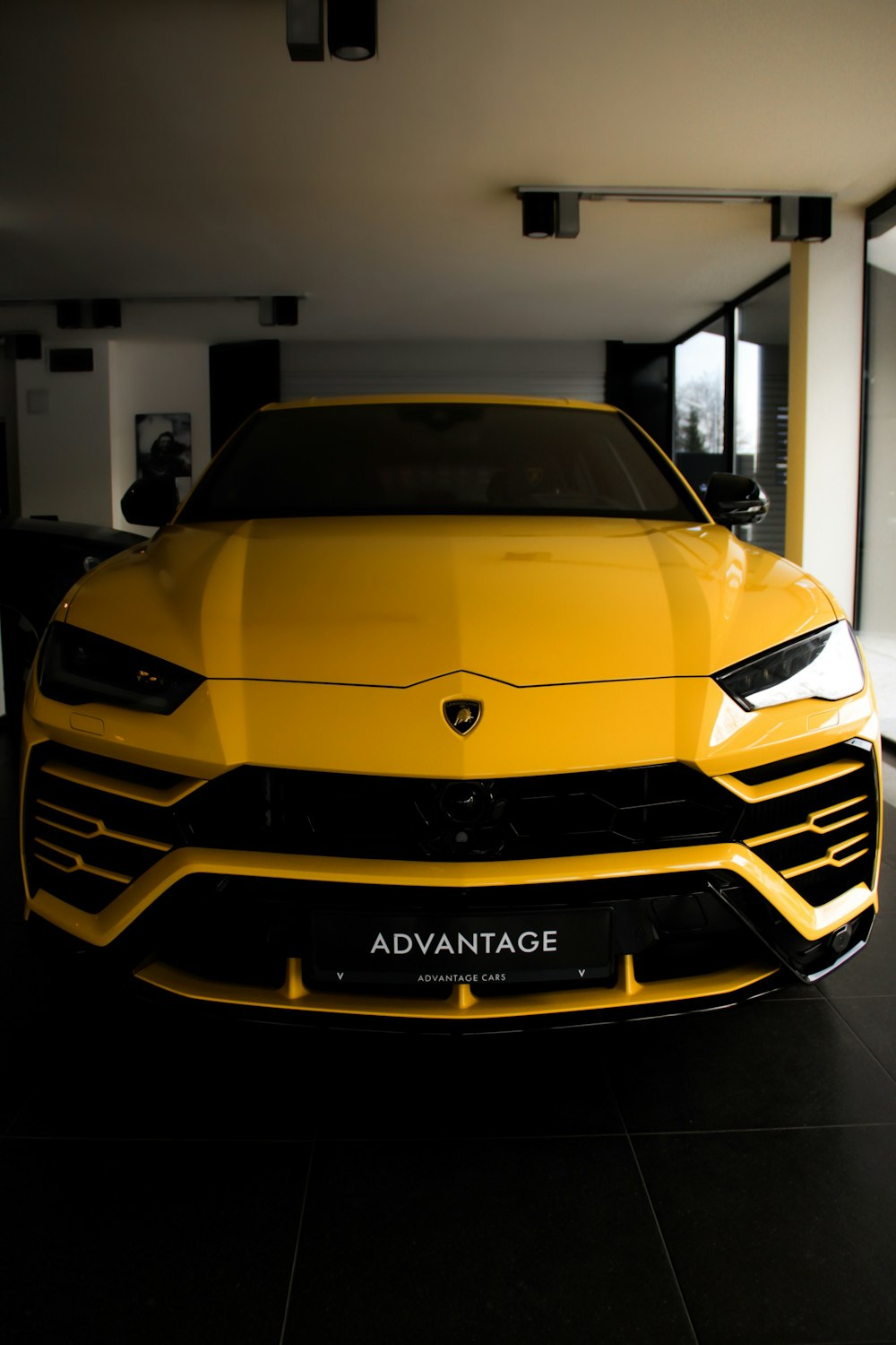 a yellow sports car parked in a garage