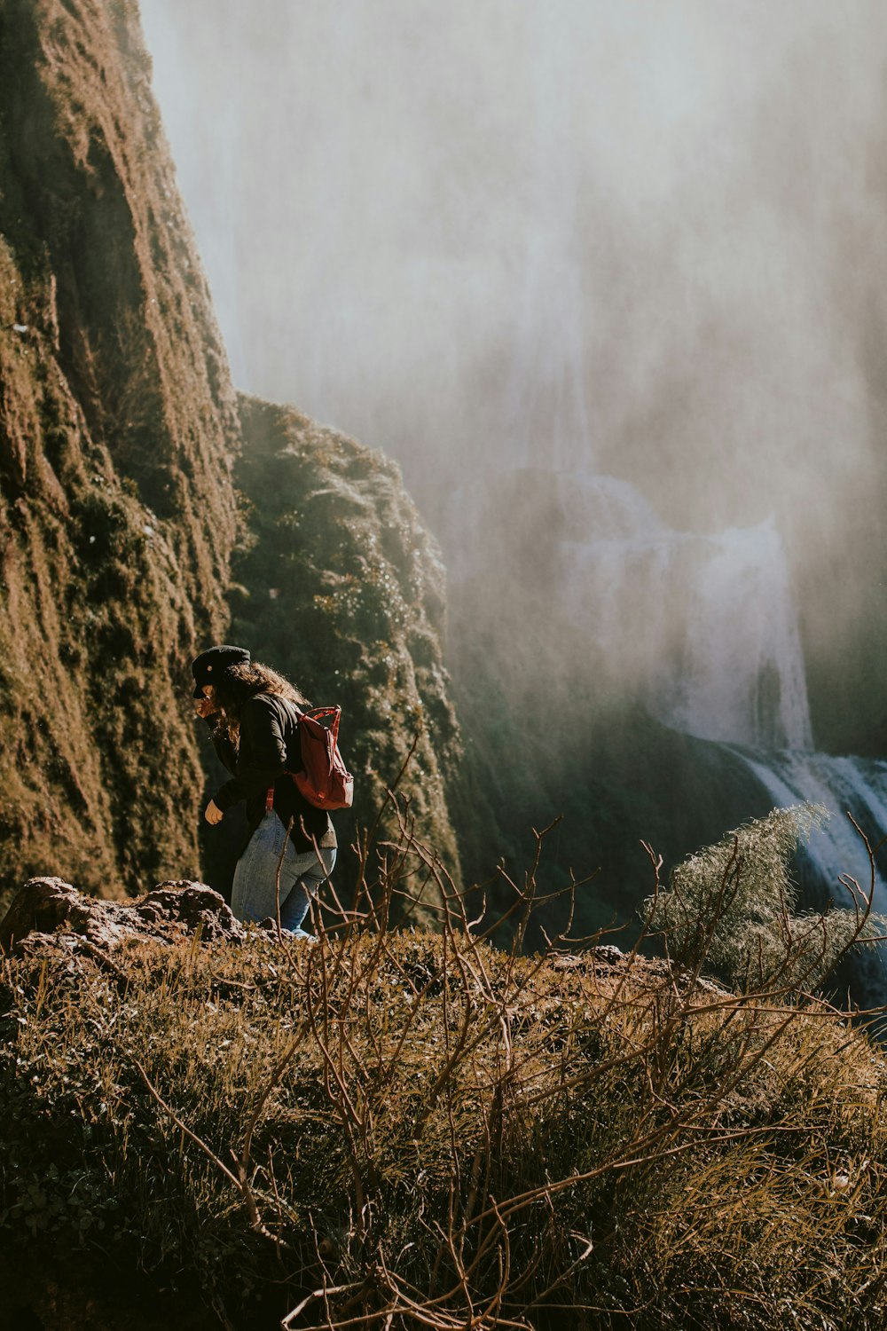 woman standing near mountain peak