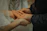 A happy couple holding their recommended wedding rings, smiling warmly.