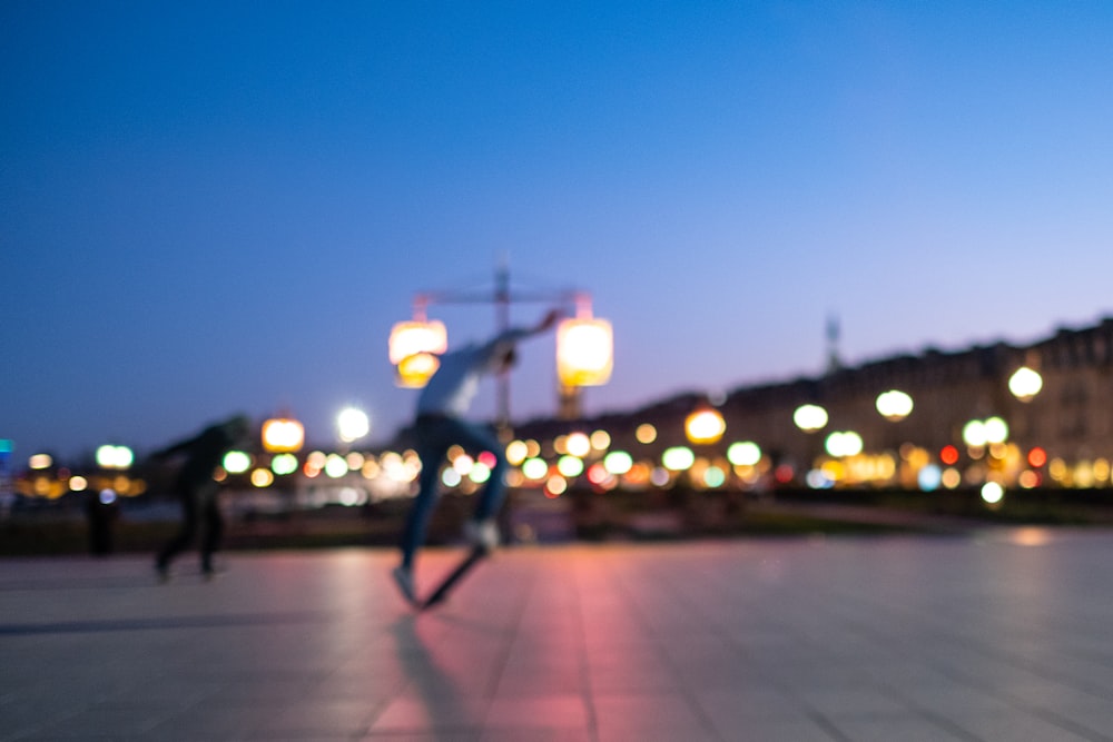 two man playing skateboard at night