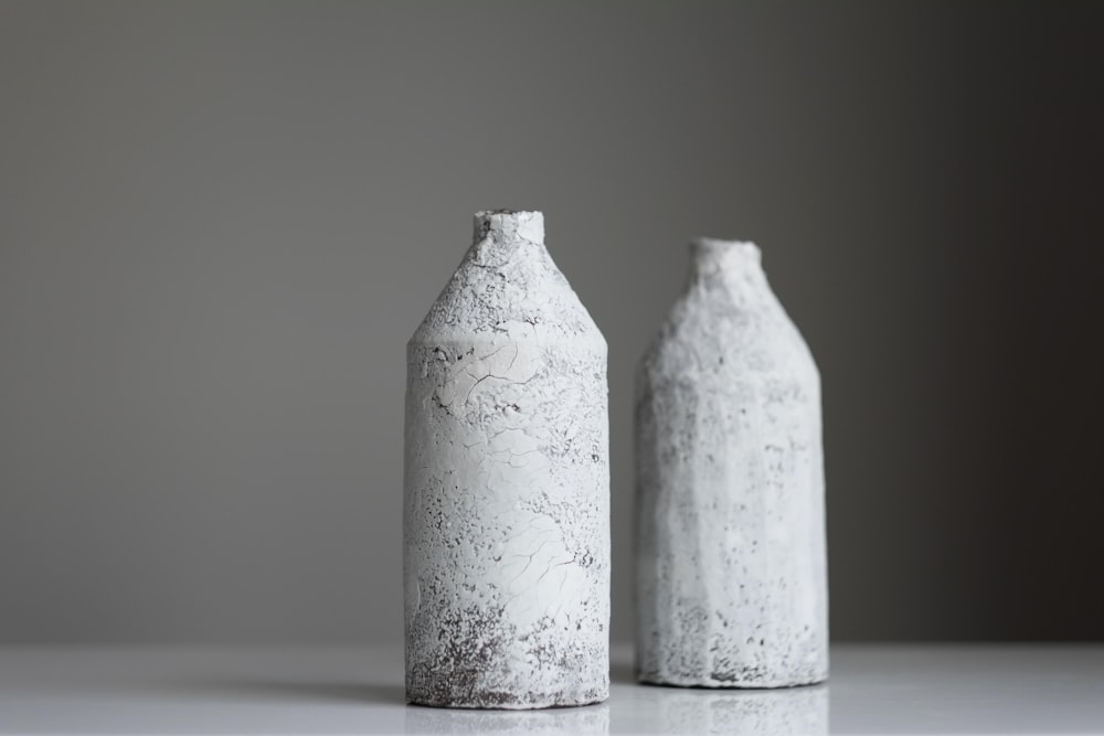 two grey bottles on surface