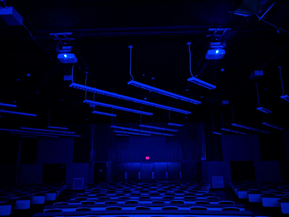 Futuristic classroom with blue and purple lighting and sleek digital screens displaying course options