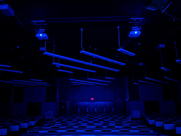 A futuristic classroom with students working on glowing robotics and AI projects under neon blue lights.