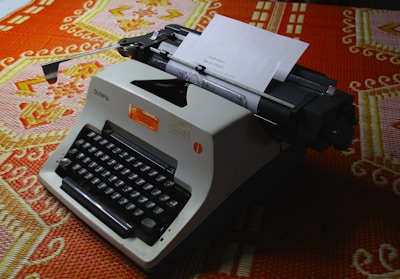 A vintage typewriter with a sheet of paper showing a curious fact.