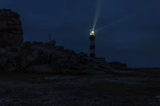 lighted lighthouse during night time