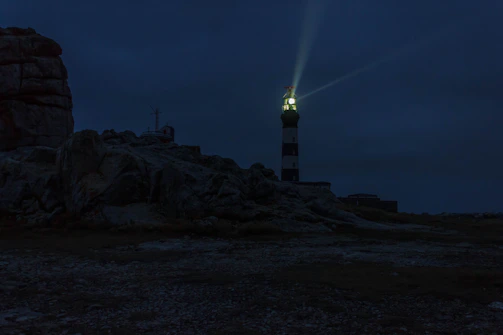 lighted lighthouse during night time