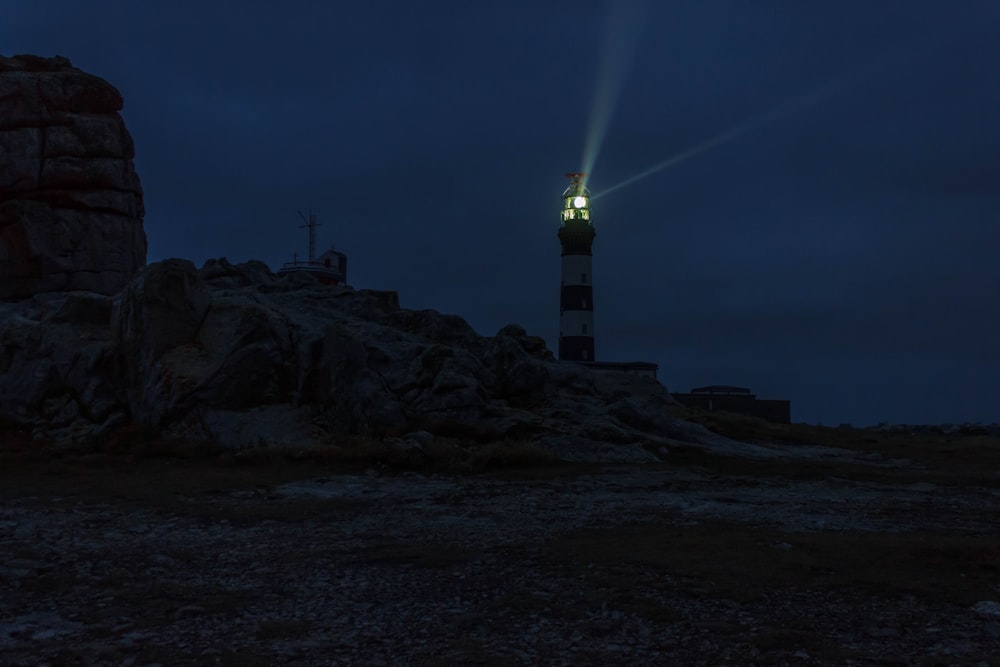 lighted lighthouse during night time