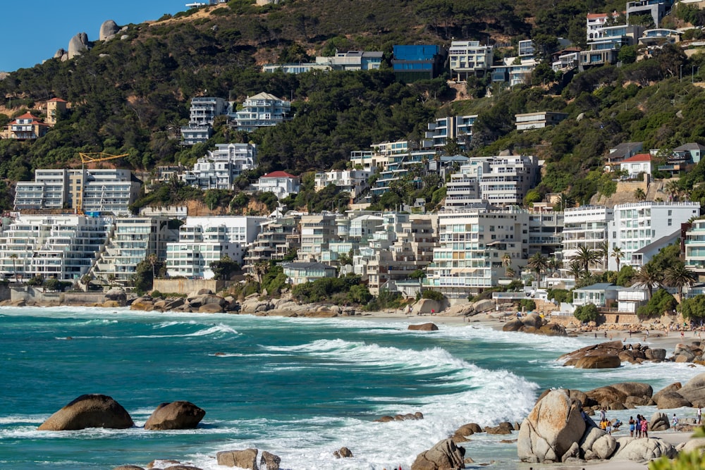 white painted buildings in front of beach during daytime