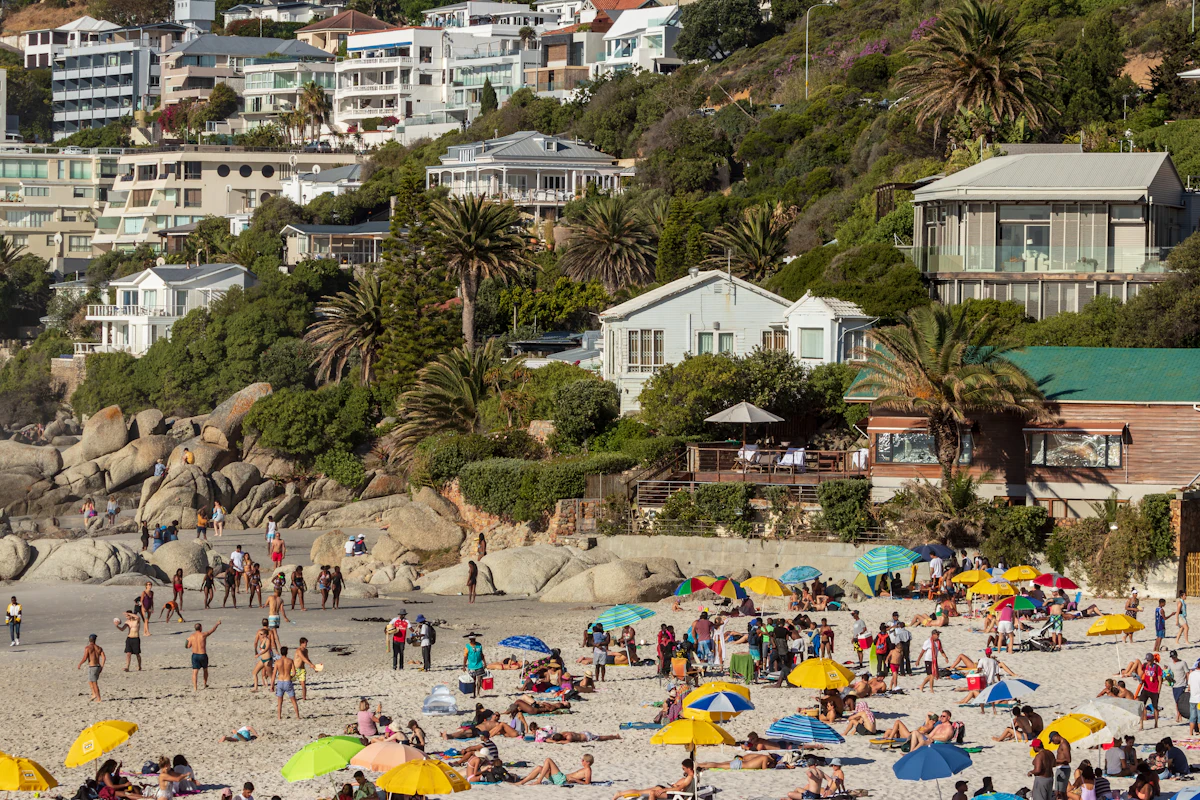 Sunbathers and umbrellas on Clifton beach in summer