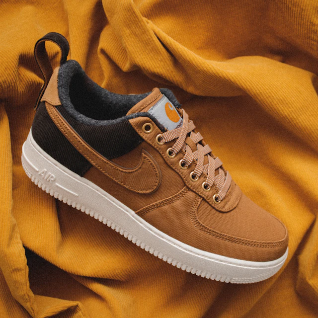 A brown Nike sneaker resting on a piece of yellow textile