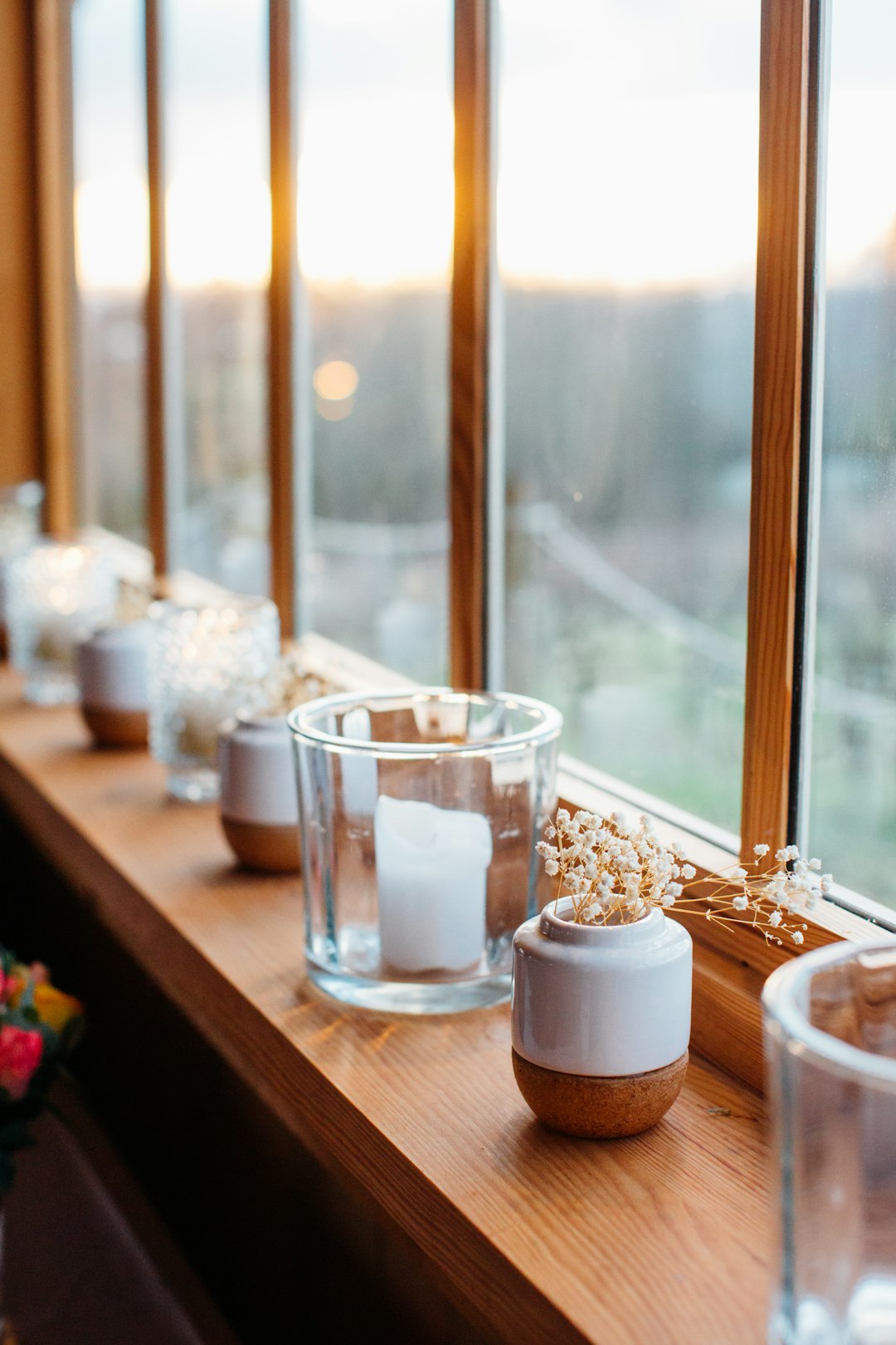 selective focus photography of clear glass pillar candle holder