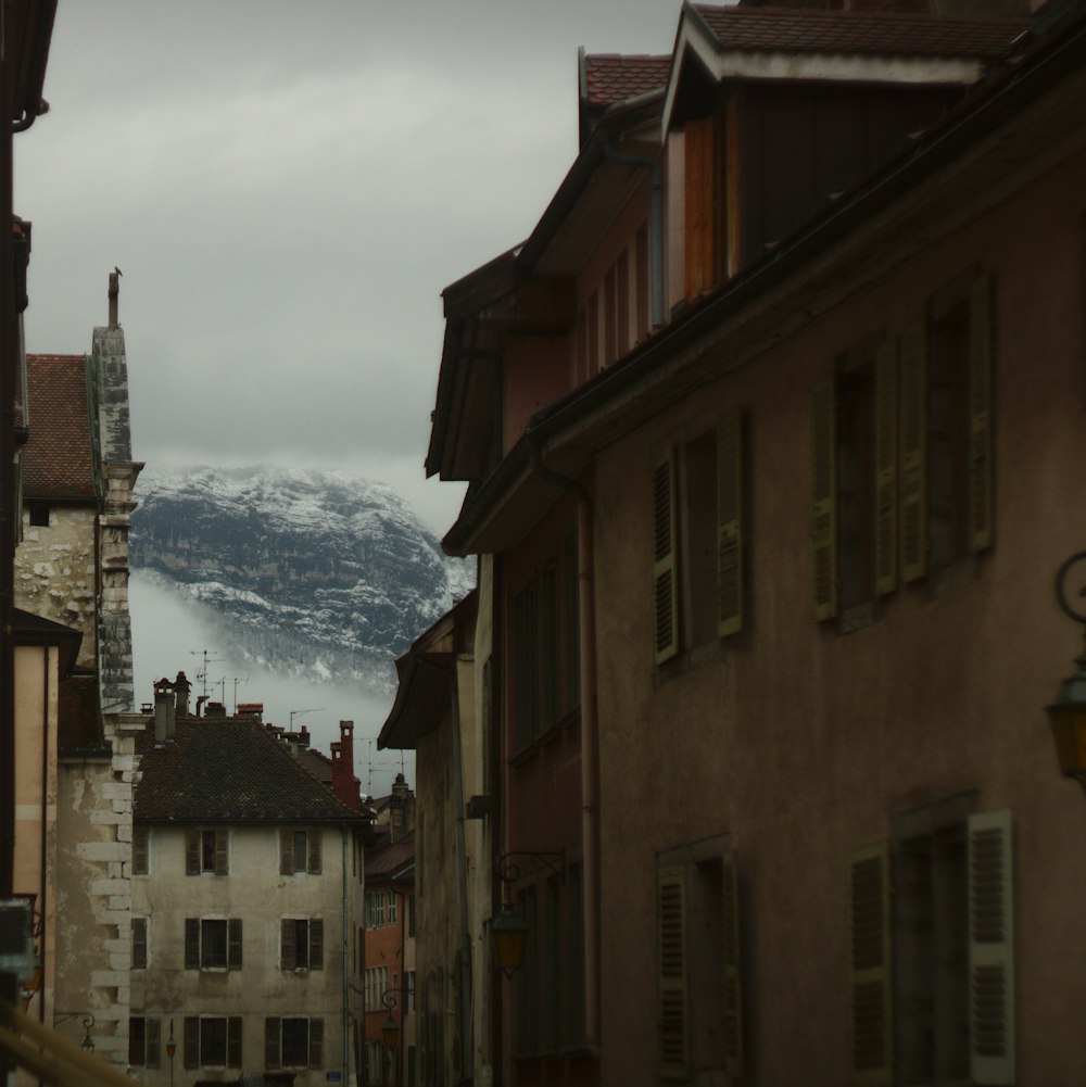 brown and grey houses near the mountain alps