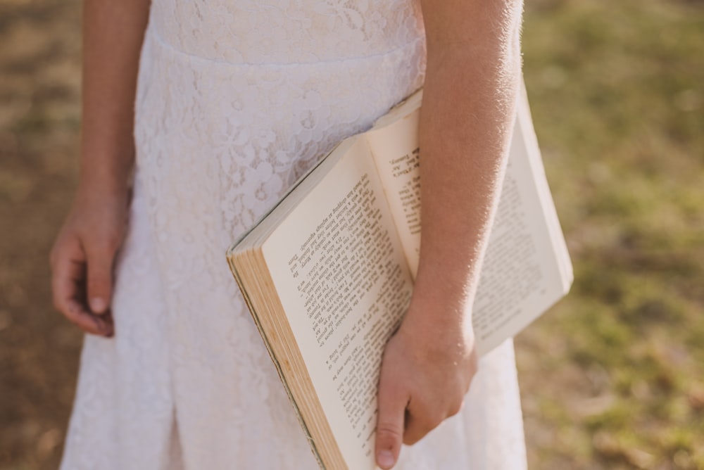 a close up of a person holding a book