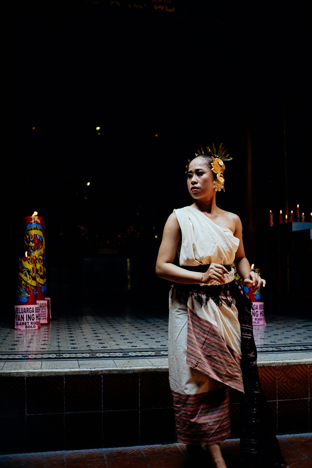 woman wearing traditional dress standing near stage