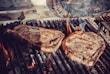Freshly grilled steaks on a barbecue grill, sizzling and juicy.