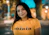smiling woman in orange crew-neck t-shirt