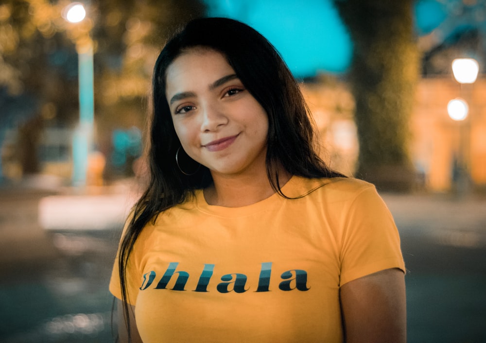 smiling woman in orange crew-neck t-shirt