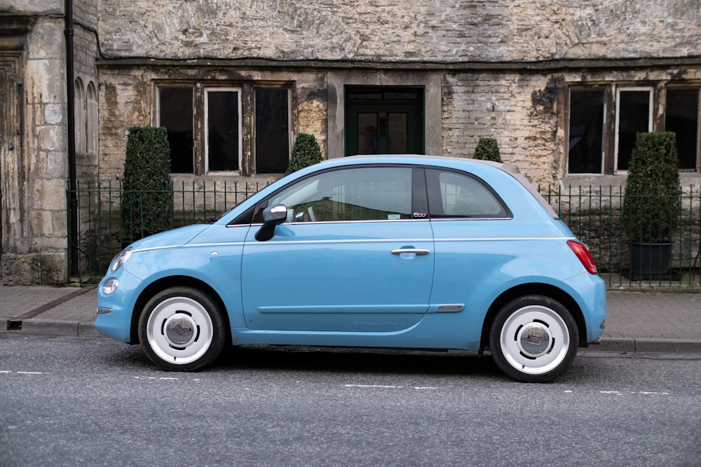 teal 3-door hatchback on road