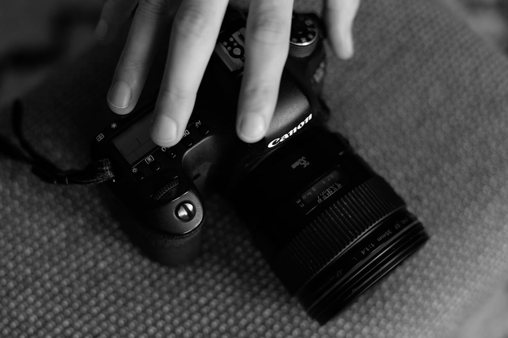 a person holding a camera with their hands