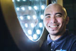 Happy man admiring his bright smile in a mirror post-treatment.