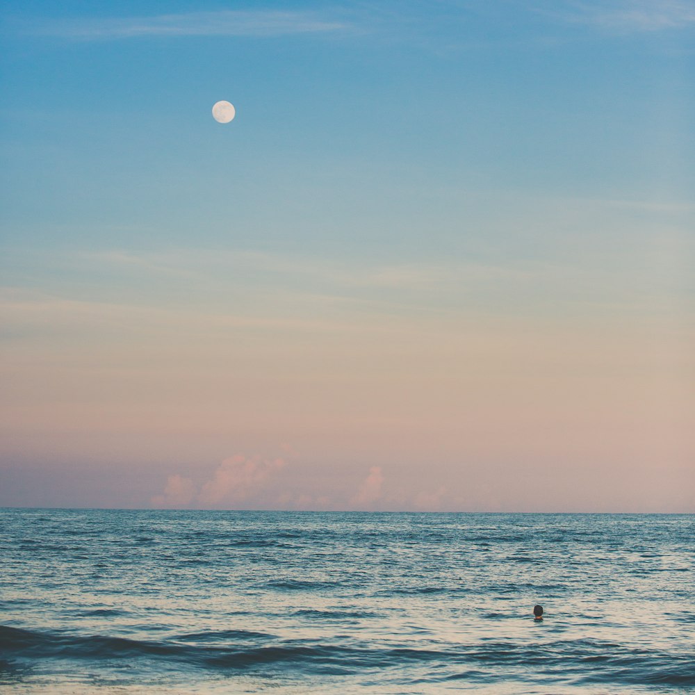 calm sea under blue sky during daytime