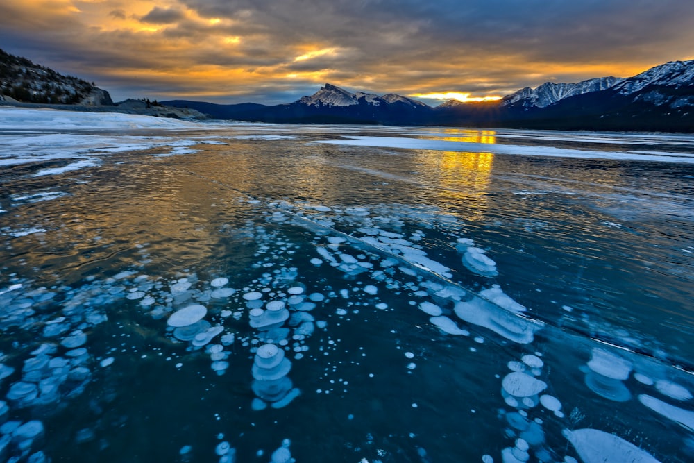 body of water under dramatic clouds