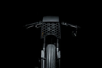 Screenshot of a dark-themed motorcycle parts e-commerce site with industrial textures.