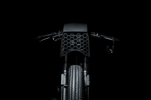 Screenshot of a dark-themed motorcycle parts e-commerce site with industrial textures.