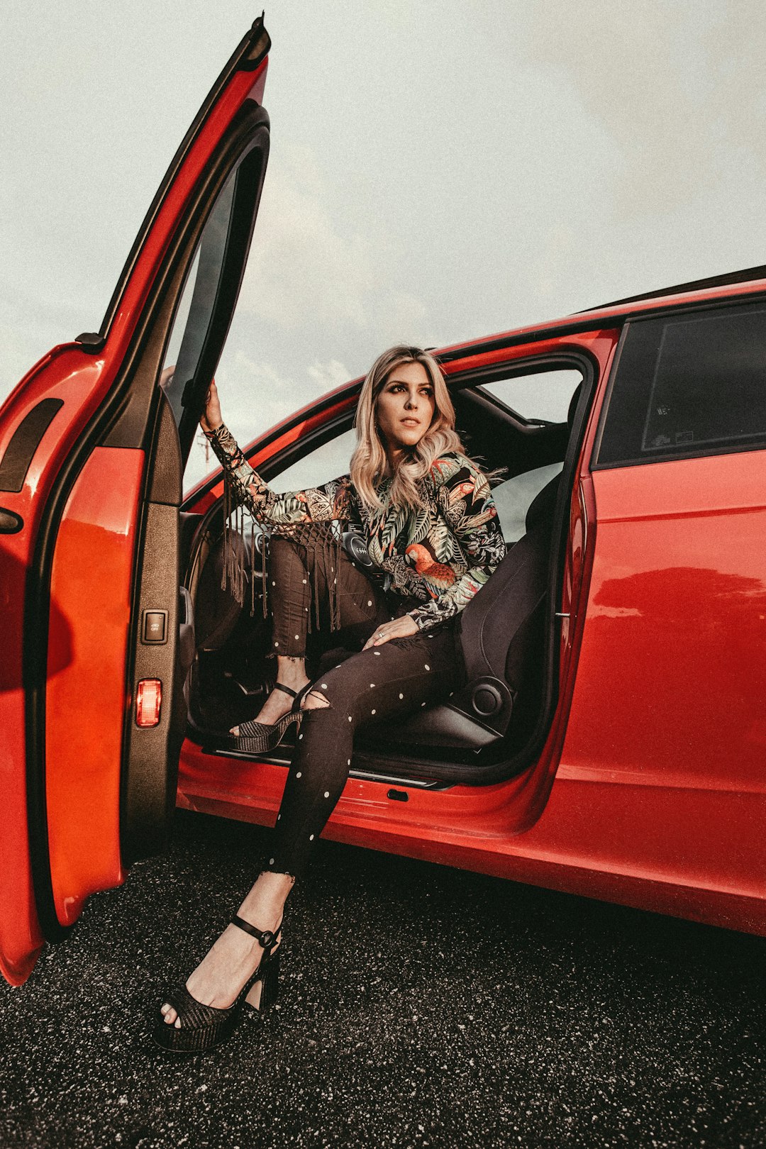 woman in black pants sitting on driver's seat