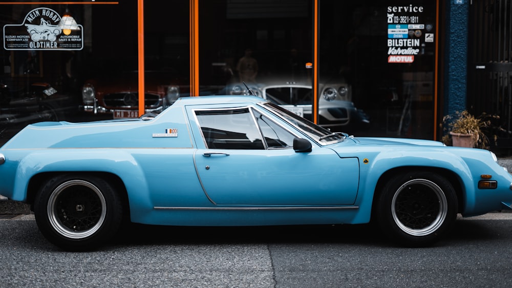 a blue car parked on the side of the road