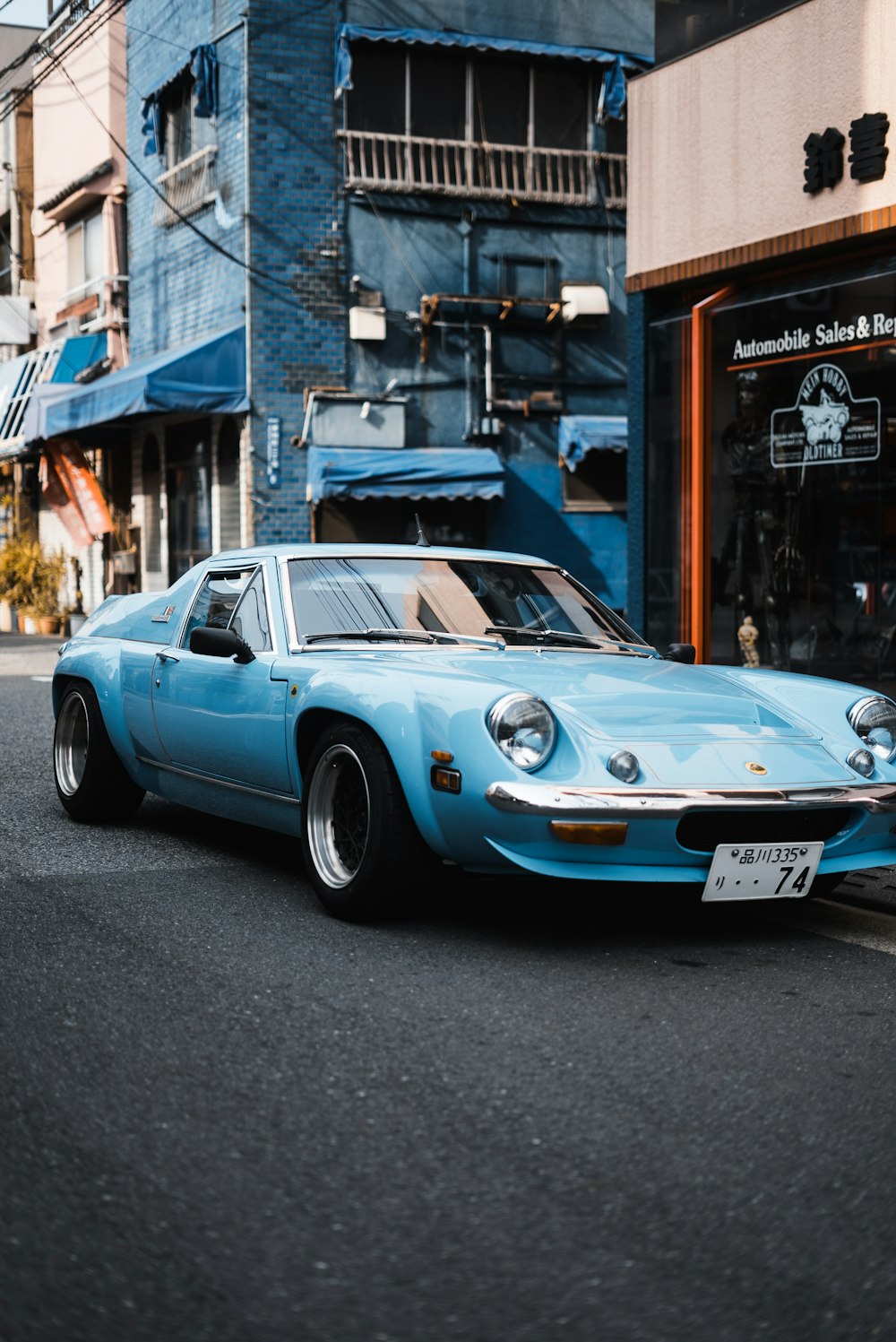 a blue car parked on the side of the road