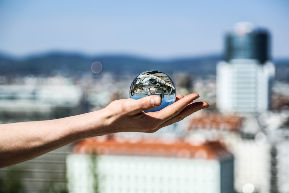 person holding clear ball