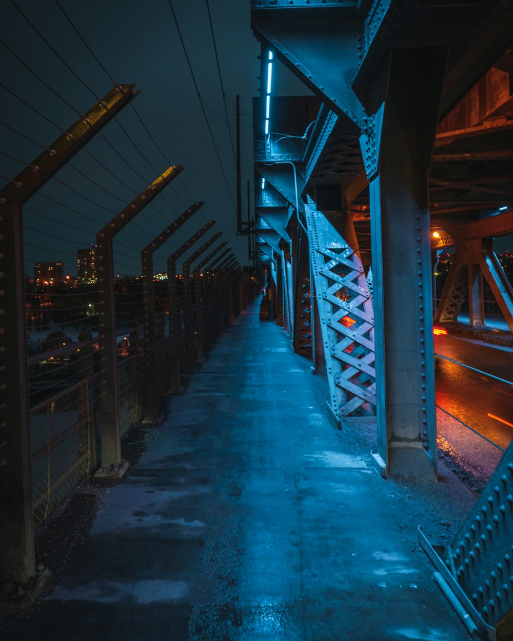blue lighted grey metal bridge