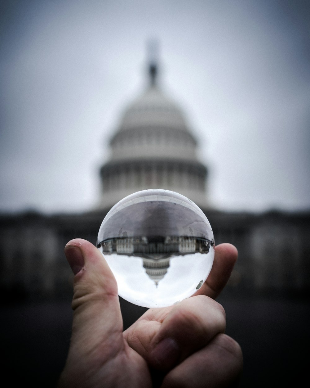 force perspective photography of glass sphere with dome building