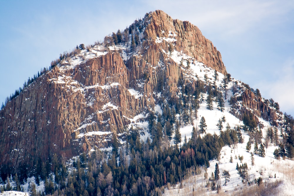 brown mountain with snow during daytime
