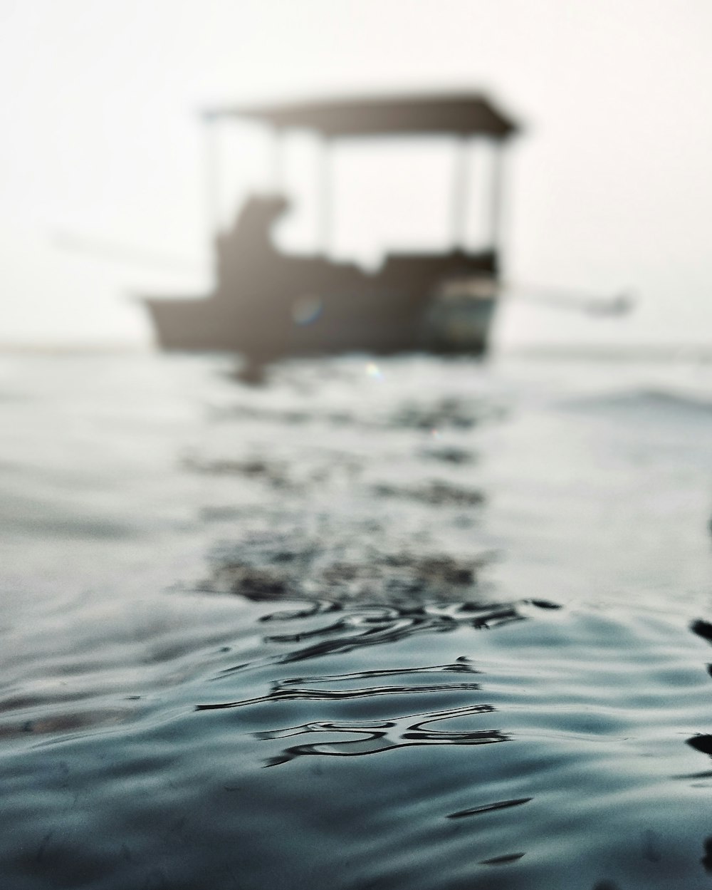 selective focus photography of boat on body of water during daytime