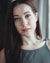 woman in gray cami top smiling